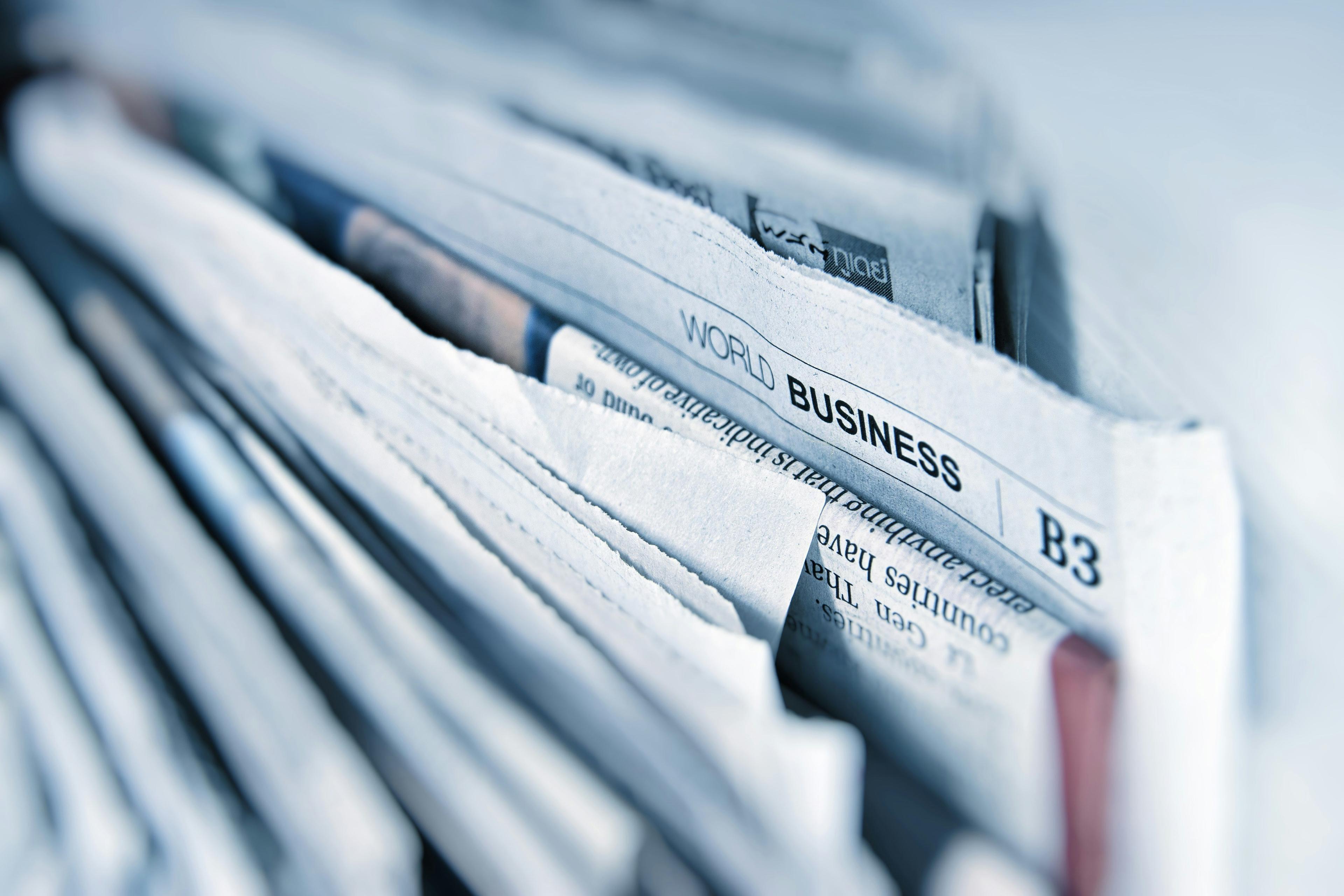 A business newspaper open on a table